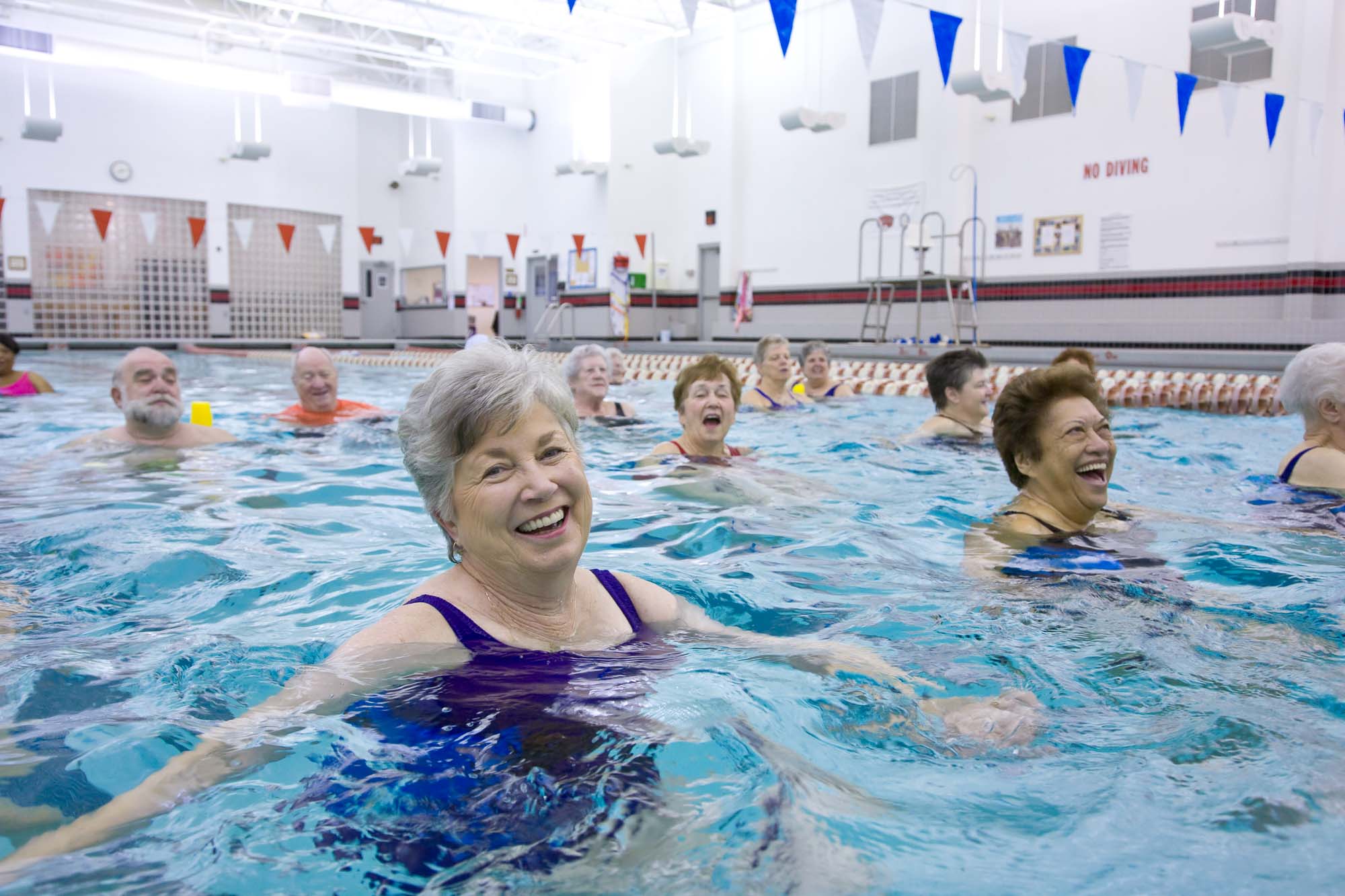 Happy Active Senior Citizens staying fit in the swimming pool