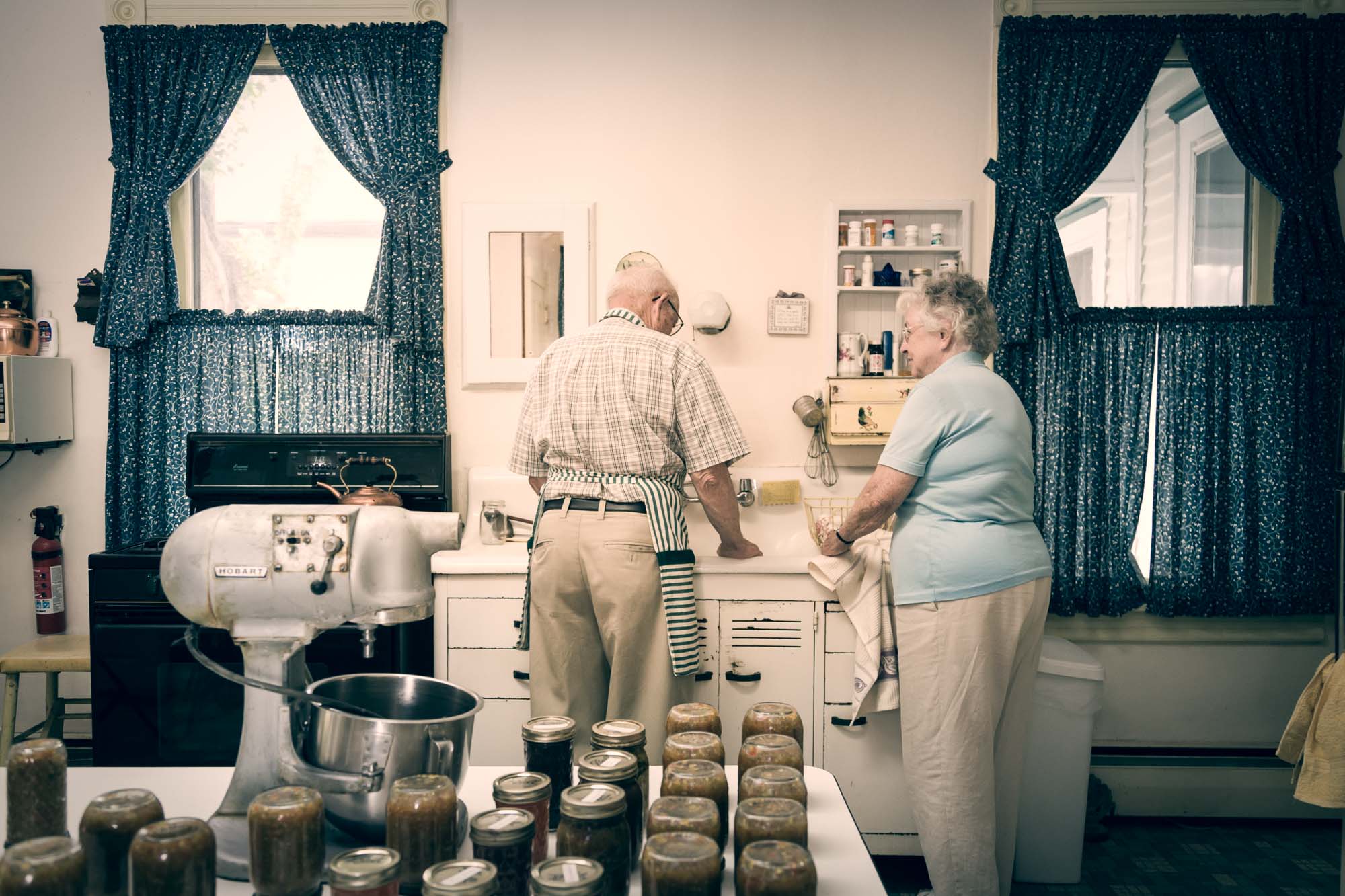 Senior Citizen Couple washing dishes together