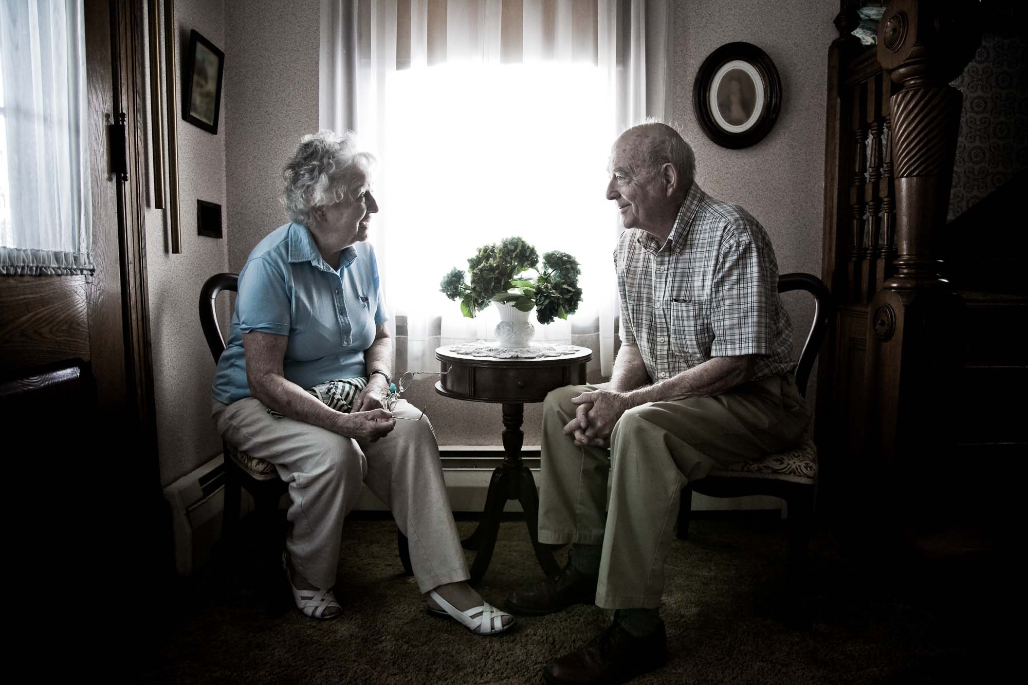Smiling Senior Romantic Couple sitting at the table