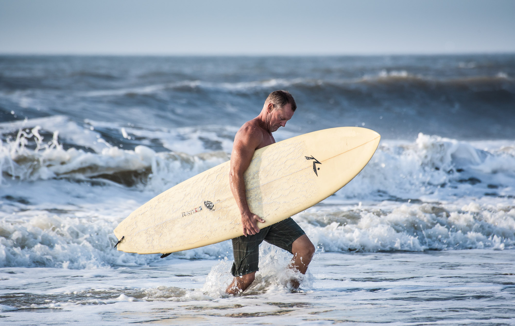 active senior citizen staying healthy by surfing