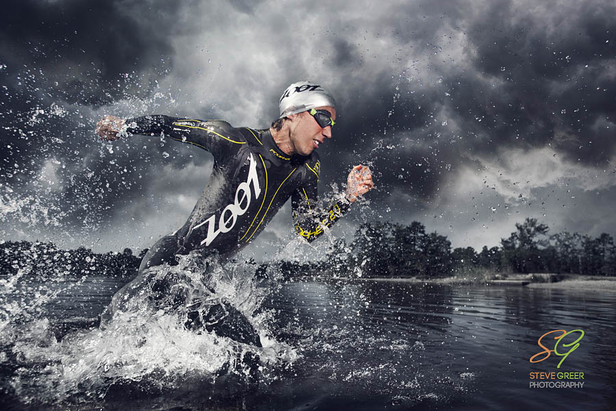 Triathlete running out of the water 