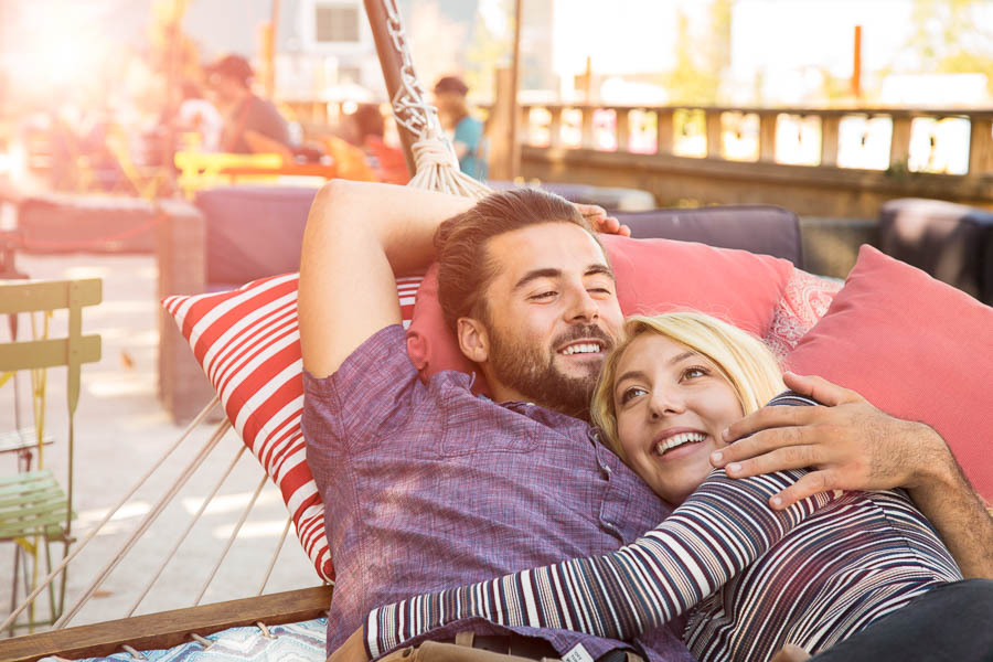 Romantic Couple Relaxing Together in Outdoor Pubic Park Hammock