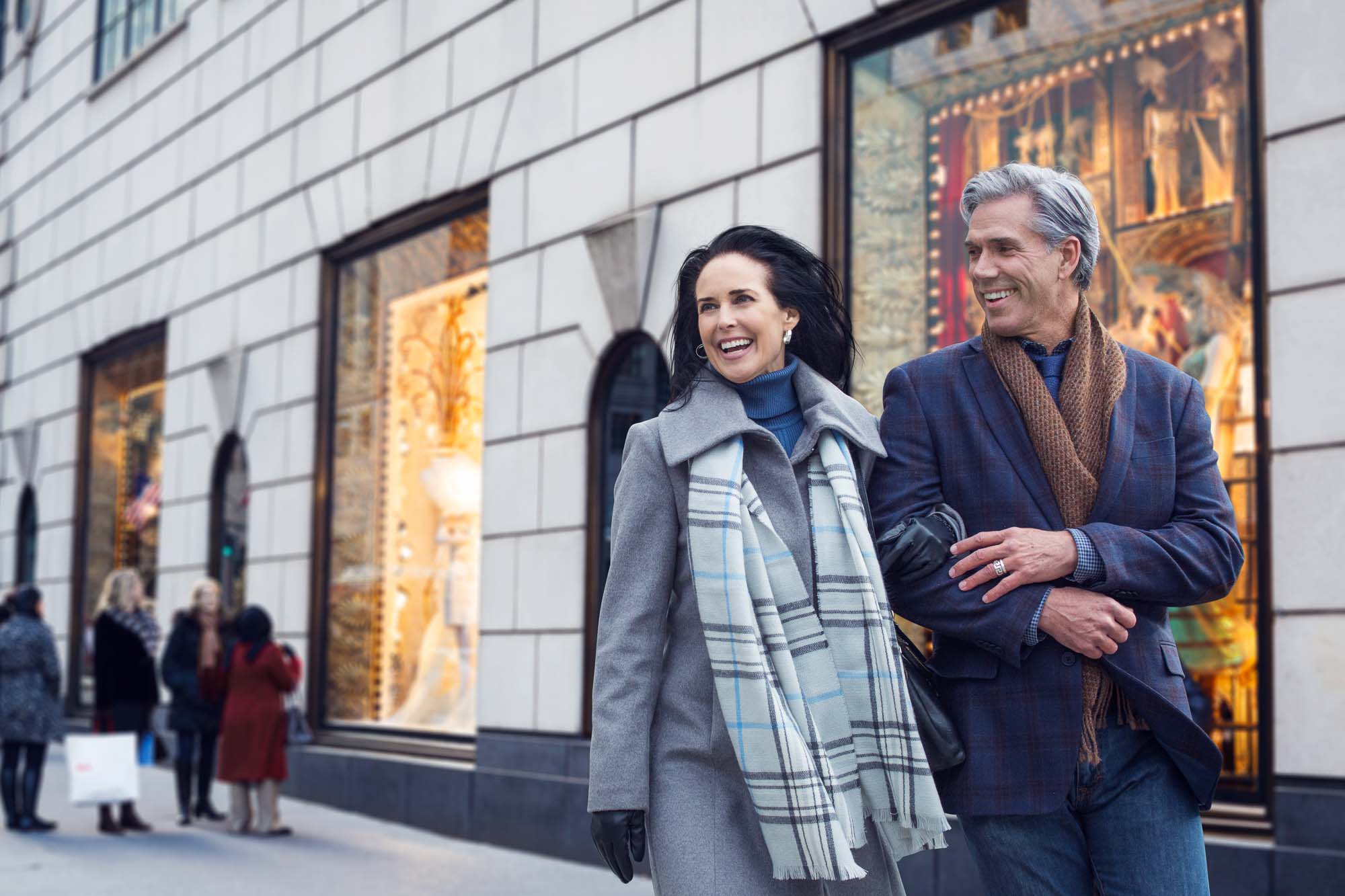 Senior Couple smiling and walking together in the city