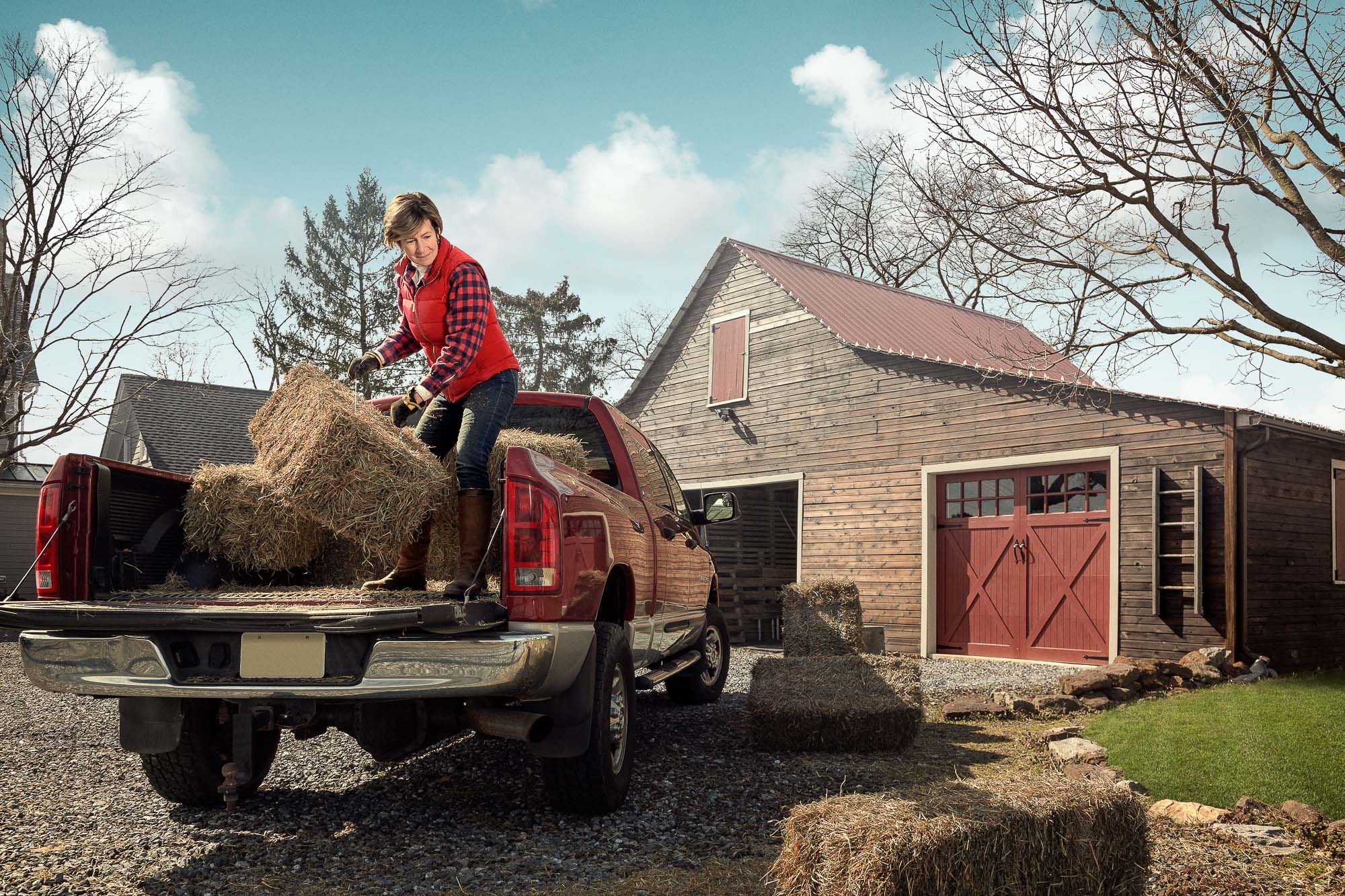 Active Senior working and lifting hay