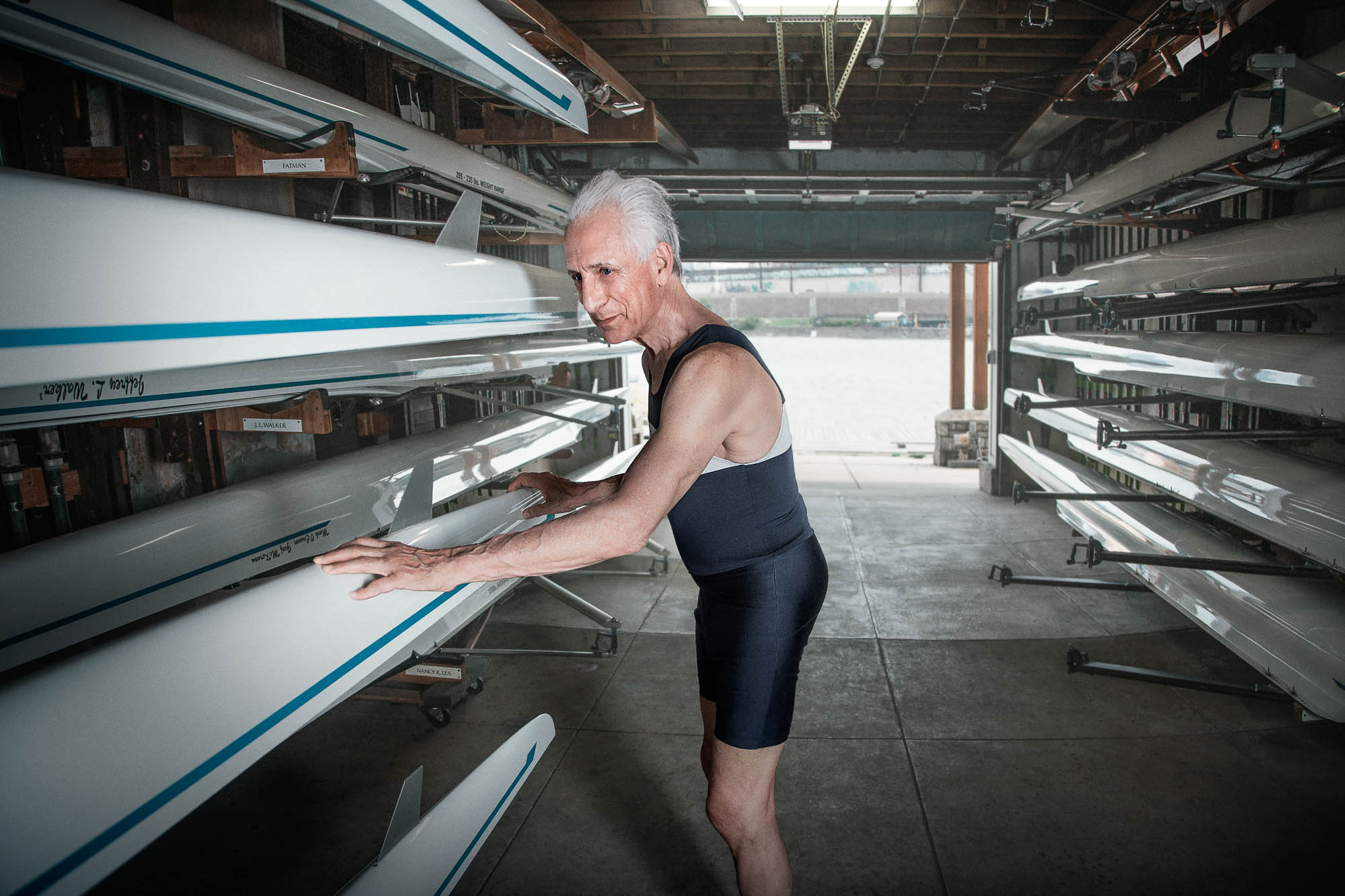active senior citizen using his rowing hobby to stay strong
