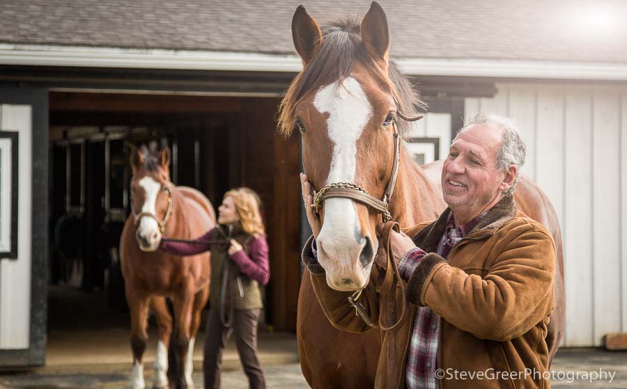 active senior citizen couple enjoying retirement with their horse hobby